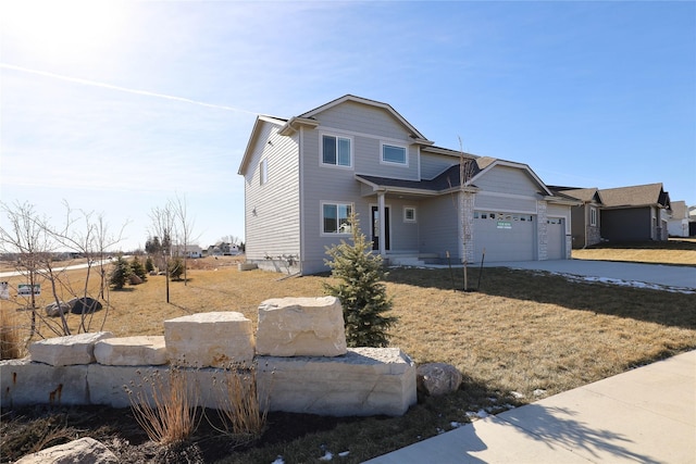 view of front of home with a garage and a front lawn