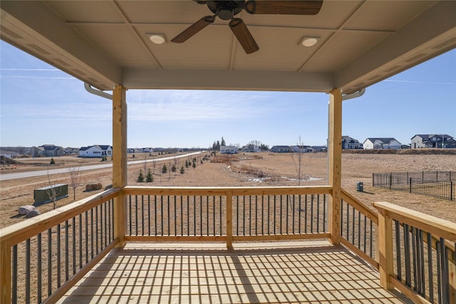 wooden deck with a ceiling fan and fence