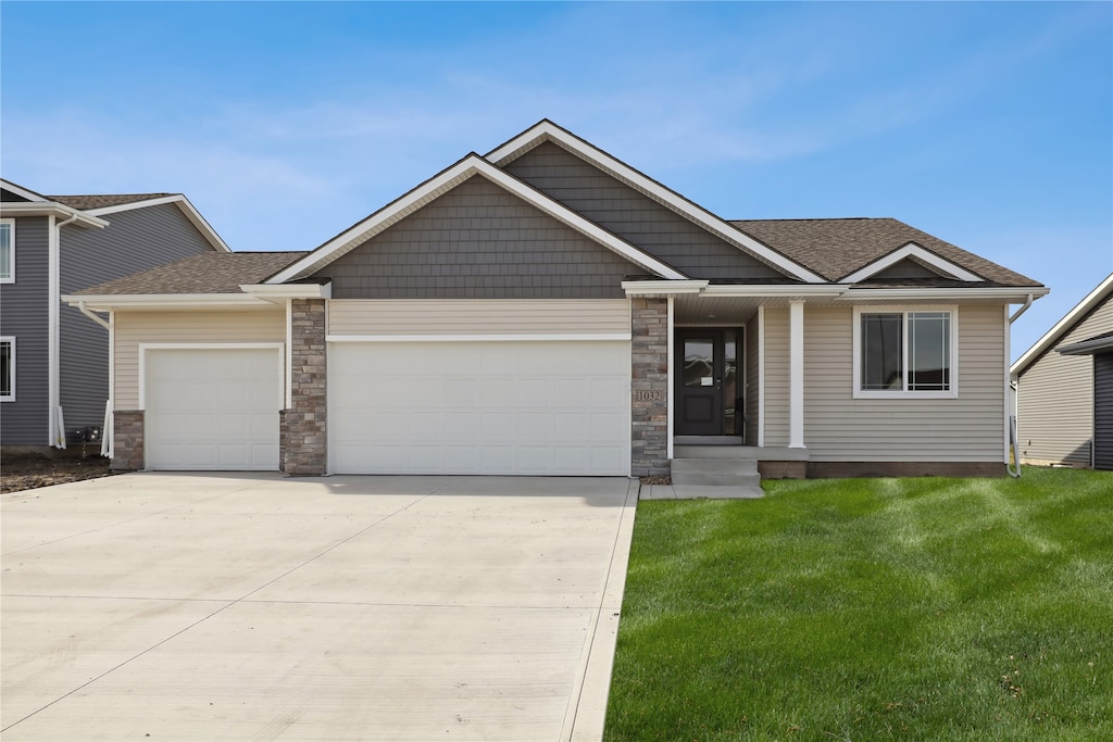 view of front of property with a garage and a front yard