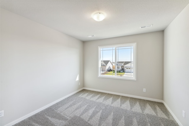 unfurnished room featuring carpet