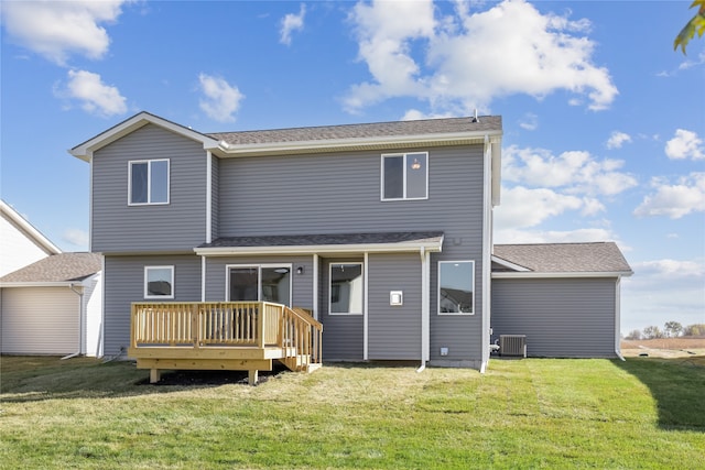 rear view of property with central AC, a deck, and a lawn