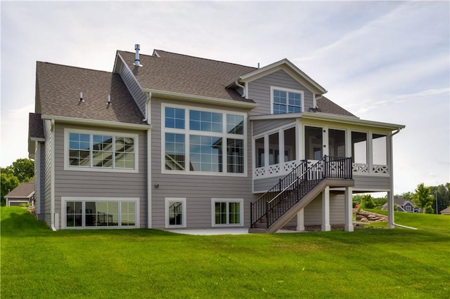 back of house featuring a yard, a shingled roof, stairway, a sunroom, and a patio area