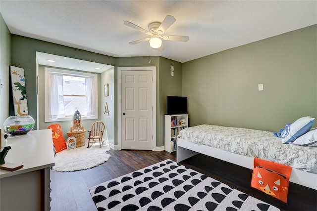 bedroom featuring a closet, ceiling fan, and dark hardwood / wood-style floors