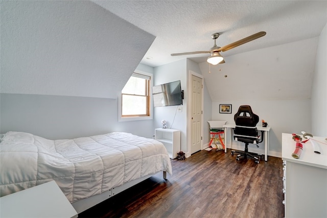 bedroom featuring vaulted ceiling, ceiling fan, dark wood-type flooring, and a textured ceiling