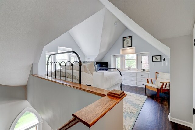 bedroom with lofted ceiling, dark hardwood / wood-style flooring, and multiple windows