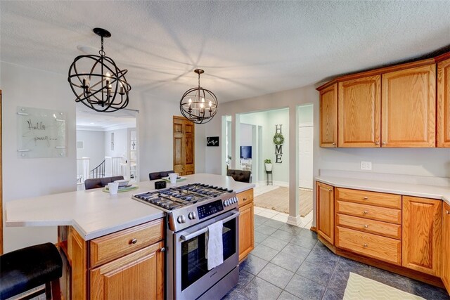 kitchen featuring pendant lighting, range with two ovens, a chandelier, and a textured ceiling