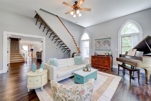 living room featuring ceiling fan and dark hardwood / wood-style floors