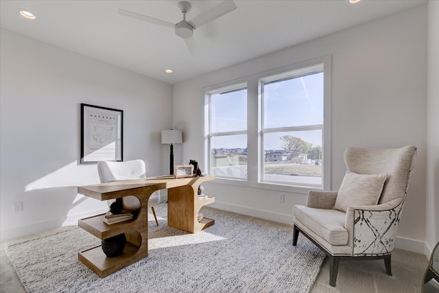 carpeted office space with ceiling fan