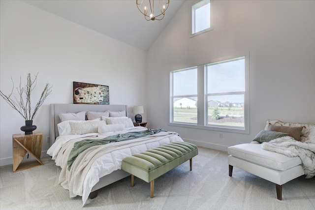 carpeted bedroom featuring a notable chandelier and high vaulted ceiling