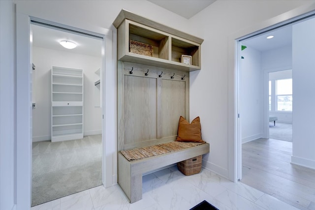 mudroom featuring light carpet