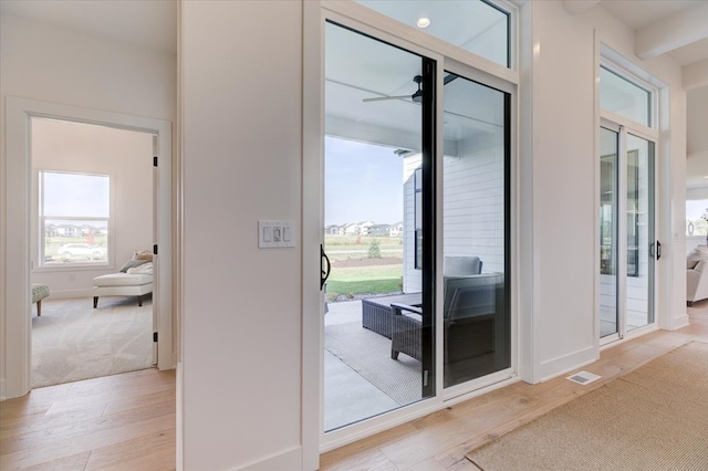 entryway with light hardwood / wood-style floors and ceiling fan