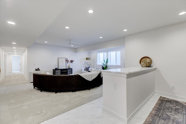 interior space with ceiling fan and light colored carpet