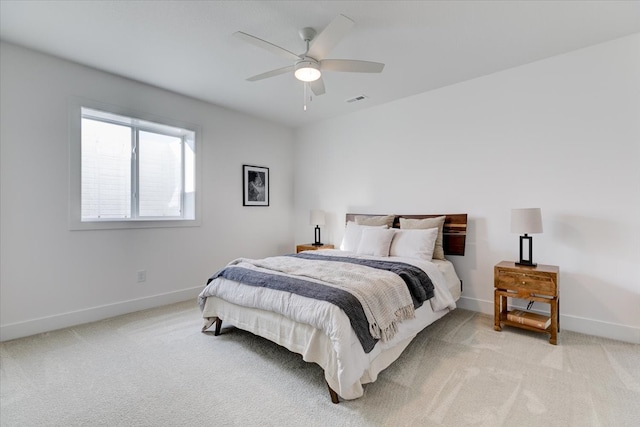 bedroom with ceiling fan and light carpet