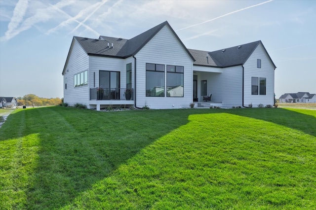 rear view of property with a yard