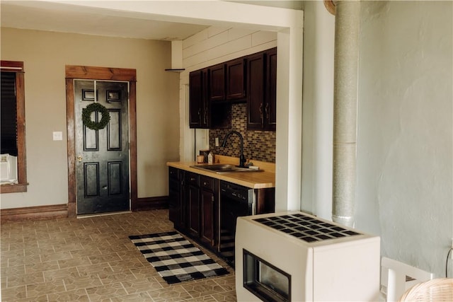 bar with a sink, tasteful backsplash, dishwasher, and baseboards