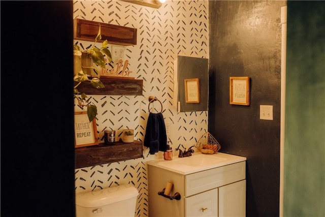 bathroom with toilet and vanity