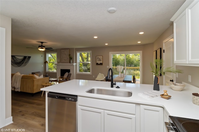 kitchen with stainless steel appliances, sink, a textured ceiling, hardwood / wood-style floors, and white cabinets