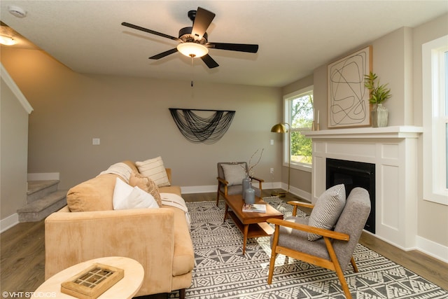 living room with ceiling fan and dark hardwood / wood-style floors