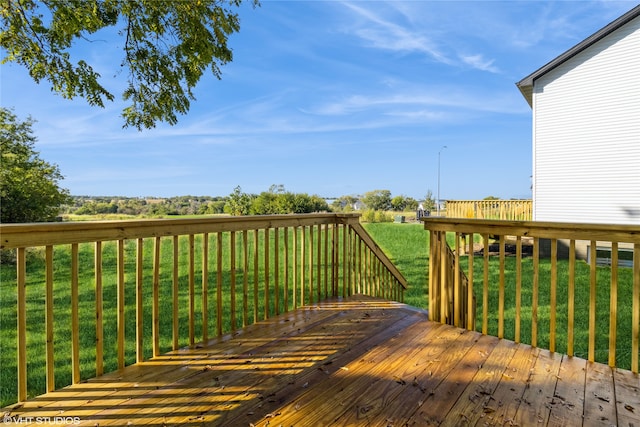 wooden terrace with a lawn