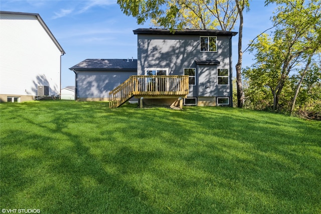 back of house featuring a wooden deck and a yard