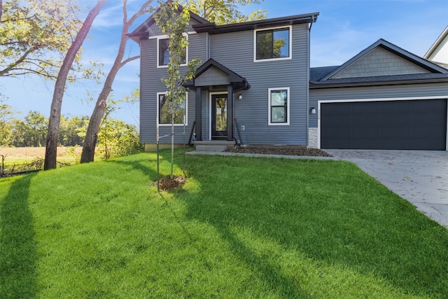 view of front of home with a garage and a front yard