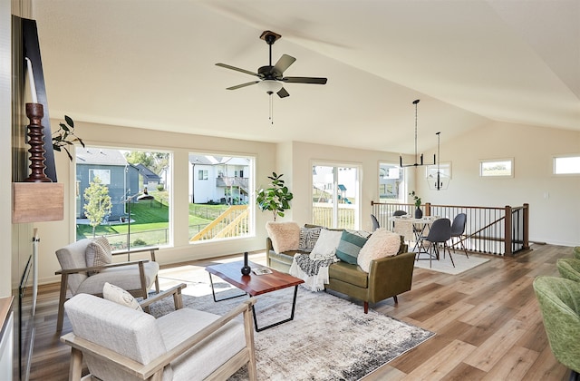 living room with vaulted ceiling, hardwood / wood-style floors, and ceiling fan