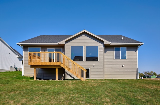 rear view of property with a yard and a deck