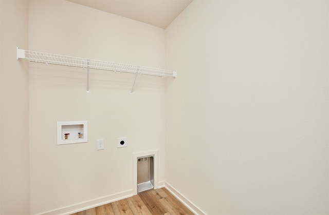 laundry area with hookup for a washing machine, light hardwood / wood-style floors, and electric dryer hookup