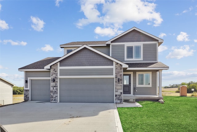 craftsman house with a garage and a front lawn