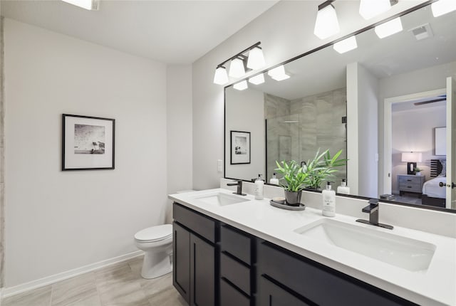 bathroom featuring vanity, tile patterned floors, a shower with shower door, and toilet