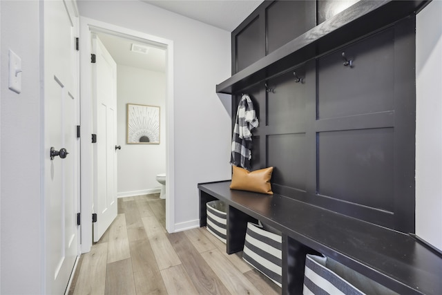 mudroom with light hardwood / wood-style floors