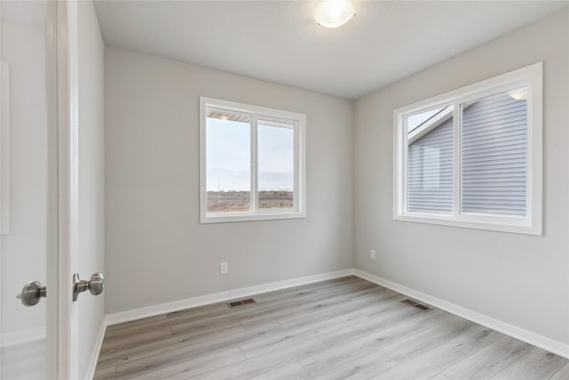 unfurnished room with light hardwood / wood-style floors