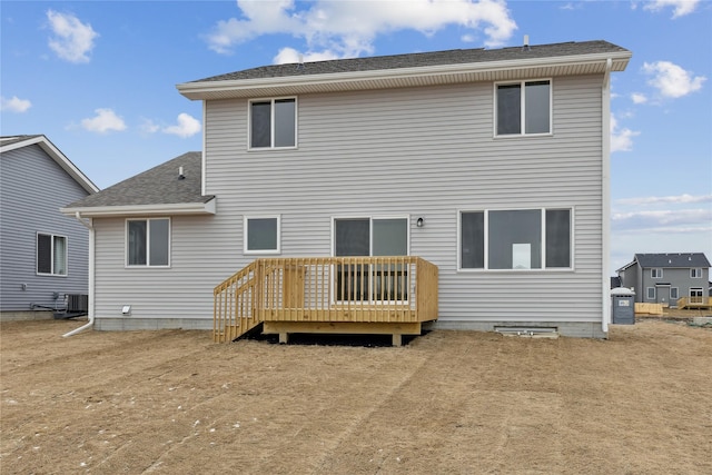 rear view of house featuring central AC unit and a wooden deck