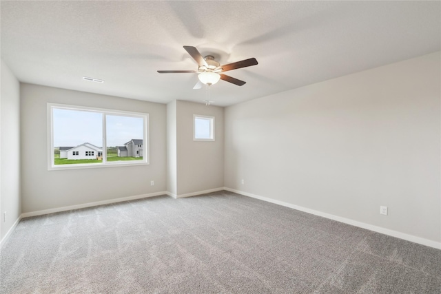 1355 Locust St, Waukee, IA 50263 - carpeted empty room featuring a ceiling fan and baseboards