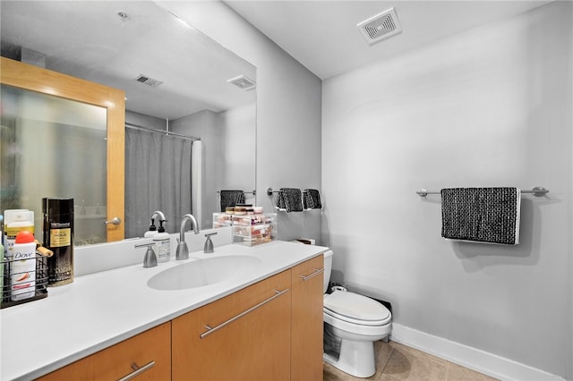 bathroom with tile patterned floors, a shower with curtain, vanity, and toilet