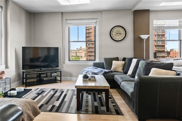 living room featuring plenty of natural light and light hardwood / wood-style floors