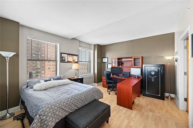 bedroom with light wood-type flooring and multiple windows