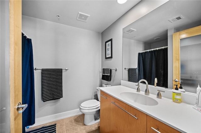 bathroom featuring tile patterned floors, vanity, and toilet