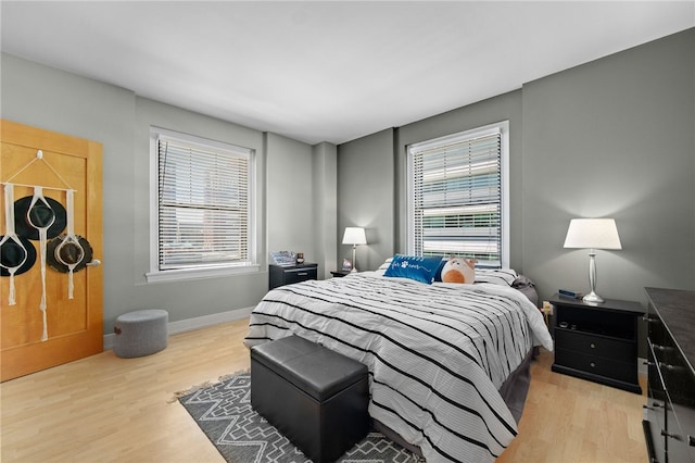 bedroom featuring light hardwood / wood-style floors and multiple windows