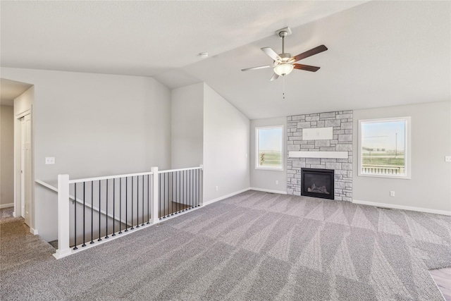 unfurnished living room with carpet floors, lofted ceiling, baseboards, and ceiling fan