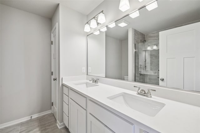 bathroom with vanity, tile patterned floors, toilet, and an enclosed shower