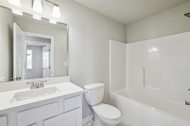 bathroom with baseboards, vanity, tub / shower combination, and toilet