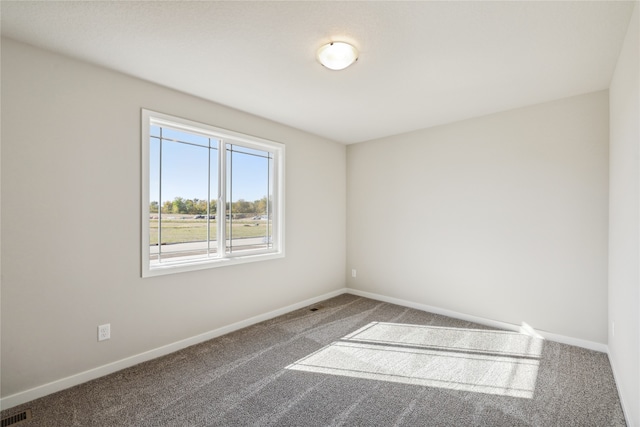 unfurnished room featuring carpet