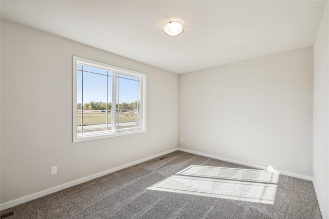 carpeted empty room with visible vents and baseboards