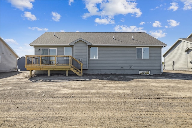 rear view of property with a wooden deck