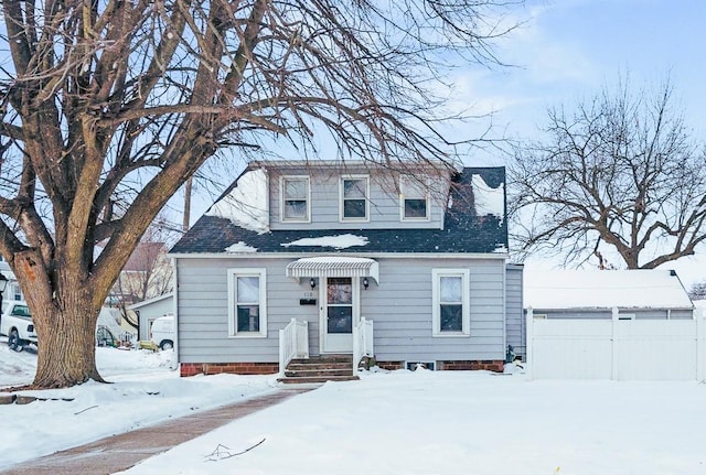 view of front of house featuring a detached garage and fence