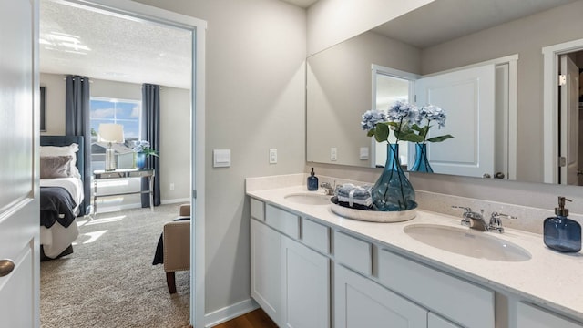 bathroom featuring a textured ceiling and vanity