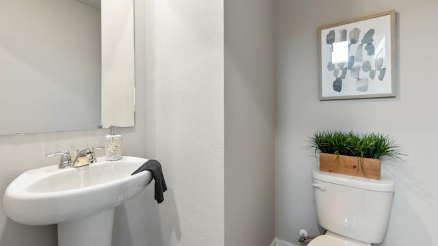 bathroom featuring toilet and sink