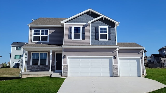 craftsman-style home featuring a front yard and a garage