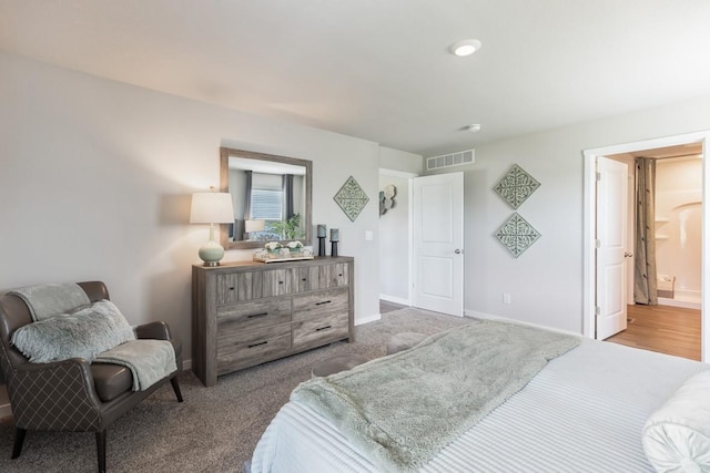 carpeted bedroom featuring visible vents and baseboards